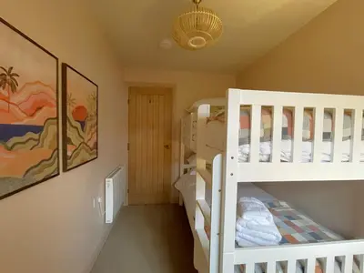 a room with two bunk beds and a ceiling at Catbells in Keswick