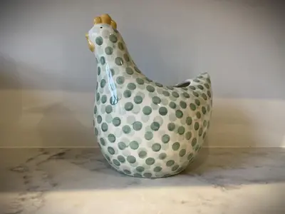 a white vase with green polka dots on it at Catbells in Keswick