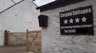 a sign on the side of a building at Cargenbank Farmhouse in Lochfoot