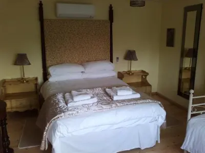 a bedroom with a bed with towels on it at Cargenbank Farmhouse in Lochfoot