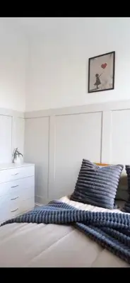 a white bedroom with a bed and a white dresser at Comfortable Carlisle Stay with Free Parking in Carlisle