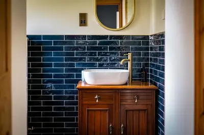 a bathroom with a sink and a mirror at The Old Vicarage Irton in Parton