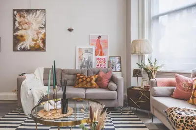 a living room with a couch and a glass table at Luxury MArylebone Village family home in Moffat