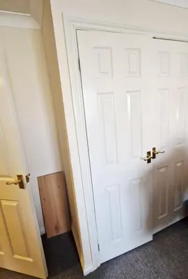 a room with a white door and a wooden box at Victory Room in Moffat