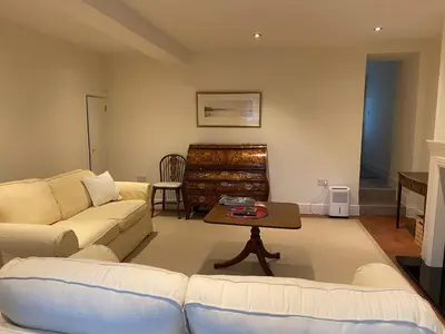a living room with a couch and a table at Bee Cottage in Moffat