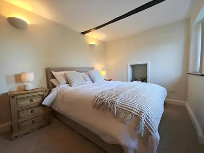 a bedroom with a large bed and a night stand at 4 Bed in Ireby oc-p34997 in Ireby
