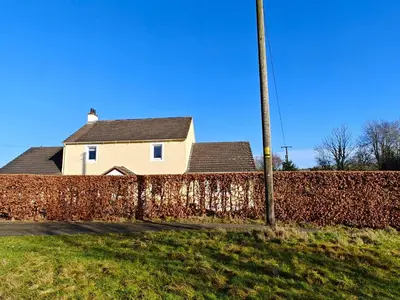 a house behind a brick fence with a pole at 4 Bed in Ireby oc-p34997 in Ireby