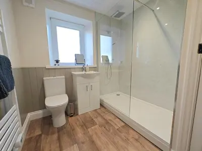a bathroom with a toilet and a shower and a sink at 4 Bed in Ireby oc-p34997 in Ireby