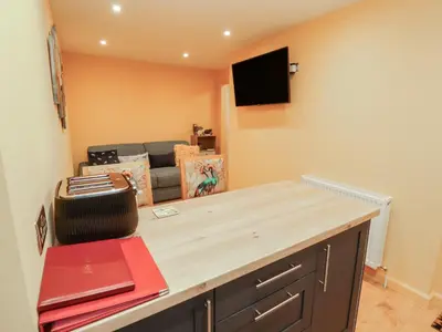 a living room with a table and a couch at The Nook in Wigton
