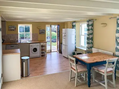 a kitchen with a wooden table and a dining room at Solway Marsh View - Uk1553 in Rockcliffe