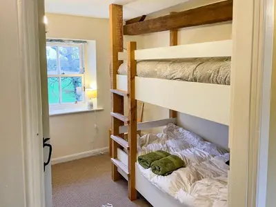 a bedroom with bunk beds and a window at Solway Marsh View - Uk1553 in Rockcliffe