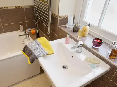 a bathroom with a white sink and a bath tub at 22 Rose Terrace in Keswick