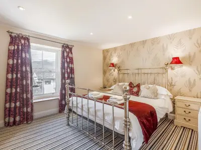 a bedroom with a bed and a window at Mary's Cottage in Keswick