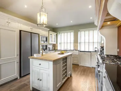 a kitchen with white cabinets and a large island at Mount Pleasant in Threlkeld
