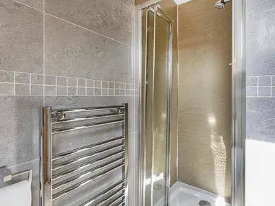 a shower with a glass door in a bathroom at Mount Pleasant in Threlkeld