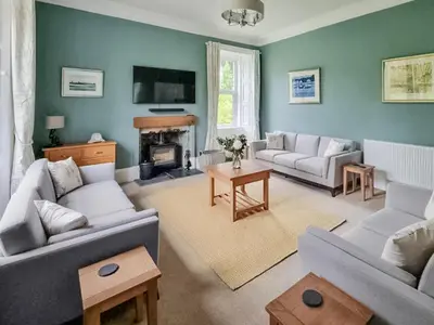 a living room with two couches and a fireplace at Lady Farm in Girvan