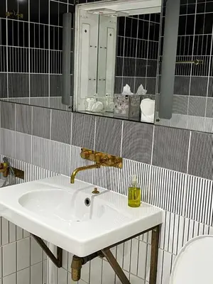 a bathroom with a sink and a mirror and a toilet at Mayfair Piccadilly Apartemnt - 3 in Moffat
