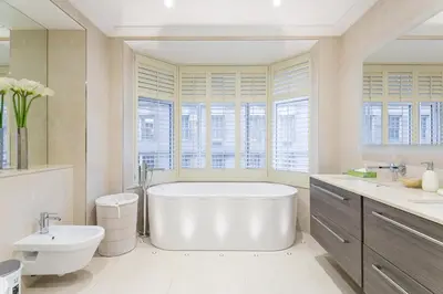 a large bathroom with a tub and a sink at Luxury 2BR Park Lane Apartment Mayfair Sleeps 6 PL15B in Moffat