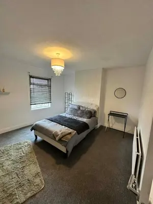 a bedroom with a large bed and a window at Comfortable Stay with Free Parking in Cleator