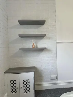 a room with a wall with shelves and a table at Comfortable Stay with Free Parking in Cleator