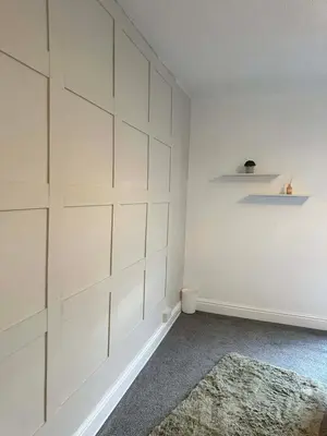 a white room with a wall with white cabinets at Comfortable Stay with Free Parking in Cleator
