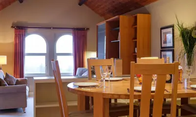 a dining room with a wooden table and chairs at Underscar - Scafell in Applethwaite