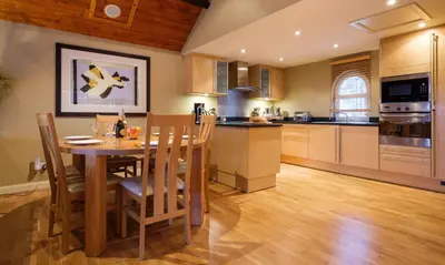a kitchen and dining room with a table and chairs at Underscar - Scafell in Applethwaite