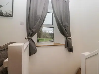 a window with gray curtains in a room at 6 Hallin Fell in Watermillock