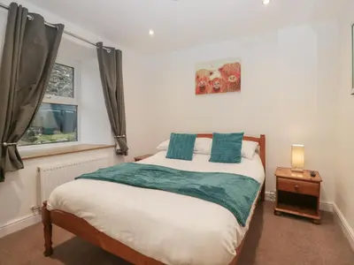 a bedroom with a bed and a window at 6 Hallin Fell in Watermillock