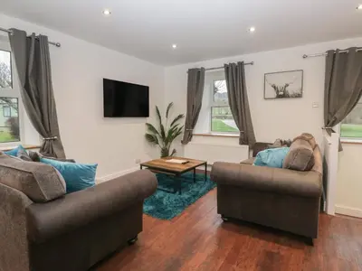 a living room with two couches and a tv at 6 Hallin Fell in Watermillock