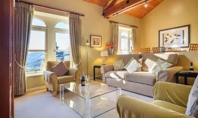 a living room with a couch and a table at Underscar - Hindscarth in Applethwaite