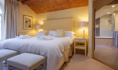 a bedroom with a large bed with towels on it at Catbells in Applethwaite