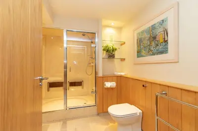 a bathroom with a shower and a toilet at Castlerigg in Applethwaite