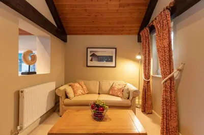 a living room with a couch and a table at Castlerigg in Applethwaite