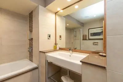 a bathroom with a sink and a bath tub at Castlerigg in Applethwaite