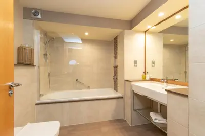 a bathroom with a tub and a sink at Castlerigg in Applethwaite
