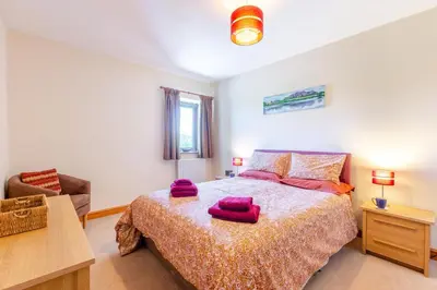 a bedroom with a bed with purple towels on it at 3 Bed in Isel oc-o32074 in Sunderland