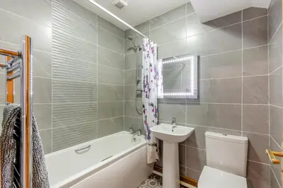 a bathroom with a sink and a toilet and a bath tub at 3 Bed in Isel oc-o32074 in Sunderland