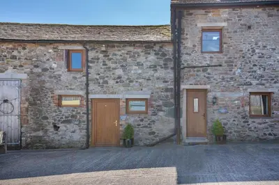 a brick building with two doors and two potted plants at 2 Bed in Isel oc-s32076 in Sunderland