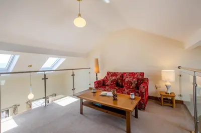 a living room with a red couch and a table at 2 Bed in Isel oc-s32076 in Sunderland