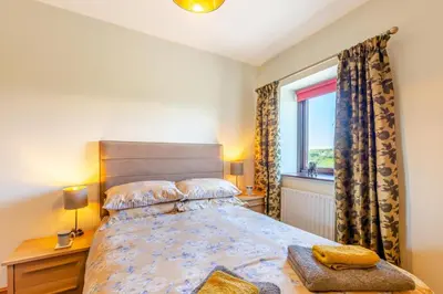 a bedroom with a large bed and a window at 2 Bed in Isel oc-o32077 in Sunderland