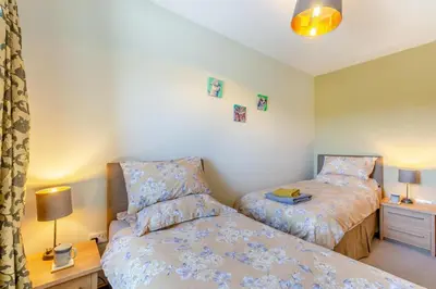 a bedroom with two beds and a table with a lamp at 2 Bed in Isel oc-o32077 in Sunderland