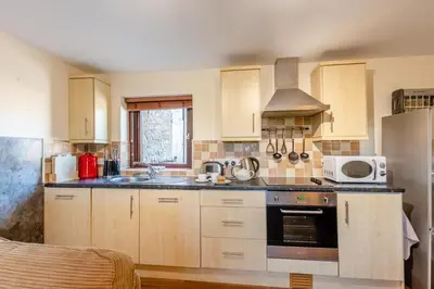 a kitchen with wooden cabinets and a stove top oven at 2 Bed in Isel oc-o32077 in Sunderland