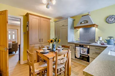 a kitchen with a wooden table with chairs and a dining room at 2 Bed in Rowrah oc-s32232 in Rowrah