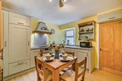 a kitchen with a wooden table and chairs in a room at 2 Bed in Rowrah oc-s32232 in Rowrah