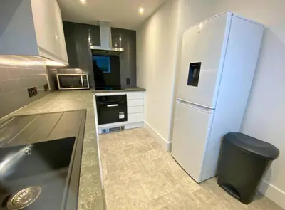 a kitchen with a refrigerator and a microwave at The Croft in Ramsey
