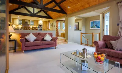 a living room with two couches and a table at Grisedale in Applethwaite