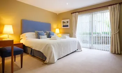 a bedroom with a bed and a large window at Underscar - High Spy in Applethwaite