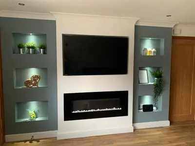 a living room with a fireplace and a flat screen tv at Fairway House- Stylish refurbished property in Moffat