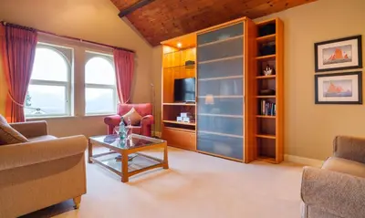 a living room with a couch and a table at Underscar - Newlands in Keswick